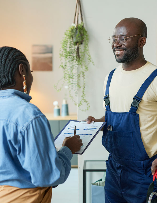 Plumbing tech getting work signed off by client.